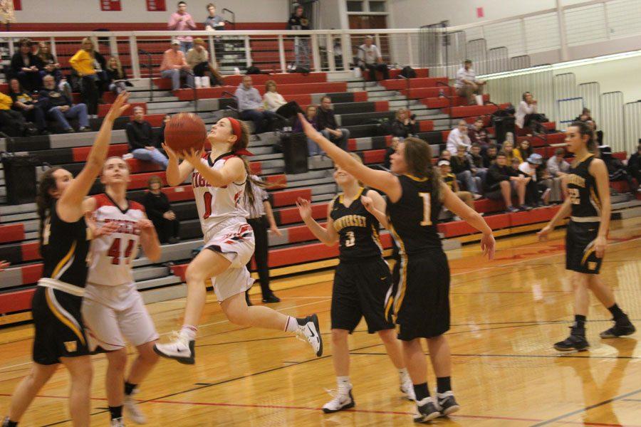 Fighting for a win, Abby Hlas drives the ball in multiple times putting up double digits in points. With the score rounding out to be 57-54, ADM Tigers finally got the win they were looking for. They hope this win will take them on a winning streak and build their confidence, Bertman said. Especially with regionals right around the corner! They play the Perry Blue Jays in their next game and are looking for the effort they put in against Winterset.