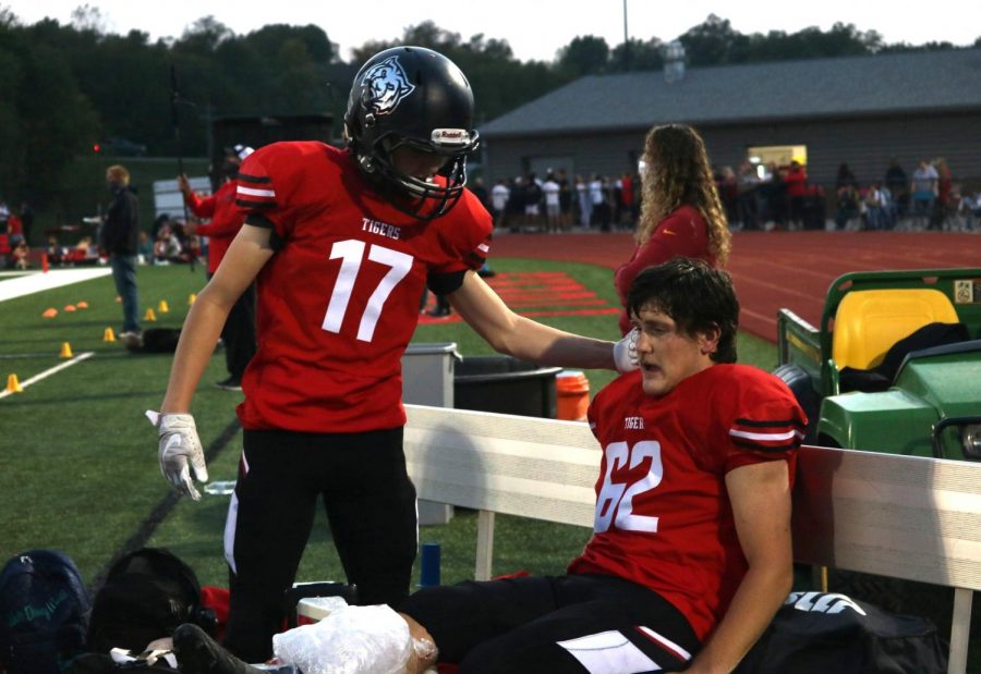 Sophomore Ben Smith (left) comforts Dallas Trigg (right) after Trigg fractured his tibia and fibula. 