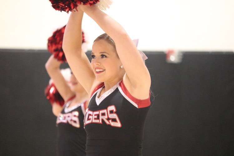 During this half-time show, Senior Sarah Moews smiles proudly, demonstrating her skills in the pom routine. 
One thing I love about dance team is all the different styles and routines we learn. 