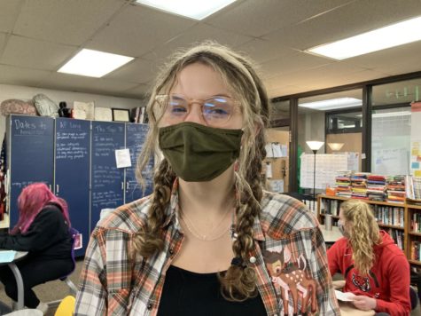 Sarena Gibson, Mays Fine Arts Student of the Month, smiles beneath her mask in the News Room. She is among the final group of people to have been nominated for this honor this year.