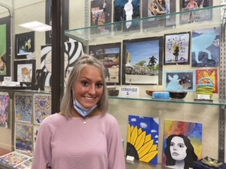 Osgood stands next to her artwork on display outside the Art room. She said, It is an honor to be recognized. Osgood and other senior artists are also featured on RRC All- Conference Senior Artists.