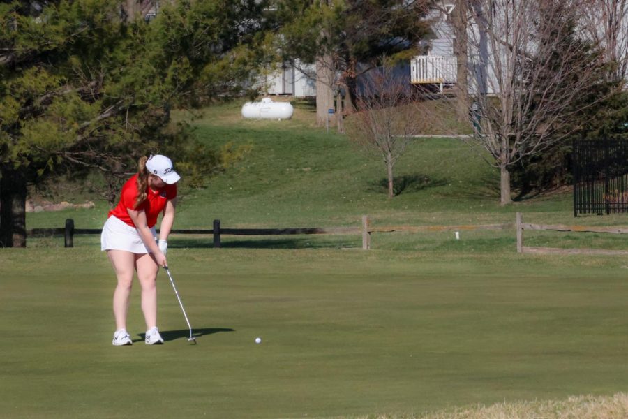 While competing against Winterset and Carslile, Book putts a long shot toward the hole. 