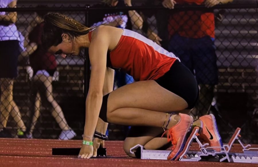 Gearing up for her race junior Makayla Crannell gets prepped in the blocks to run the first leg of the 4x100. 