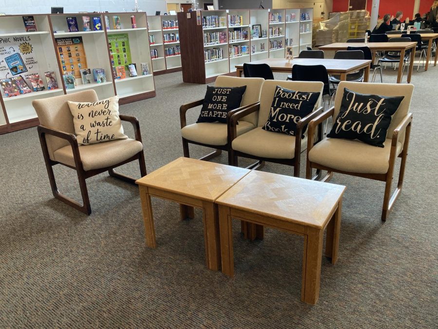 Pillows+featuring+book+sayings+sit+ready+for+students+to+enjoy+what+the+library+has+to+offer.+The+Book+Club+gathers+in+the+middle+school%2Fhigh+school+library.+There+are+always+new+book+displays+around+the+library+that+feature+different+kinds+of+books+for+those+looking+for+a+book+to+read.+