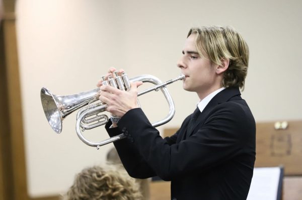 Keegan Holdmeyer playing his trumpet during a band contest. 