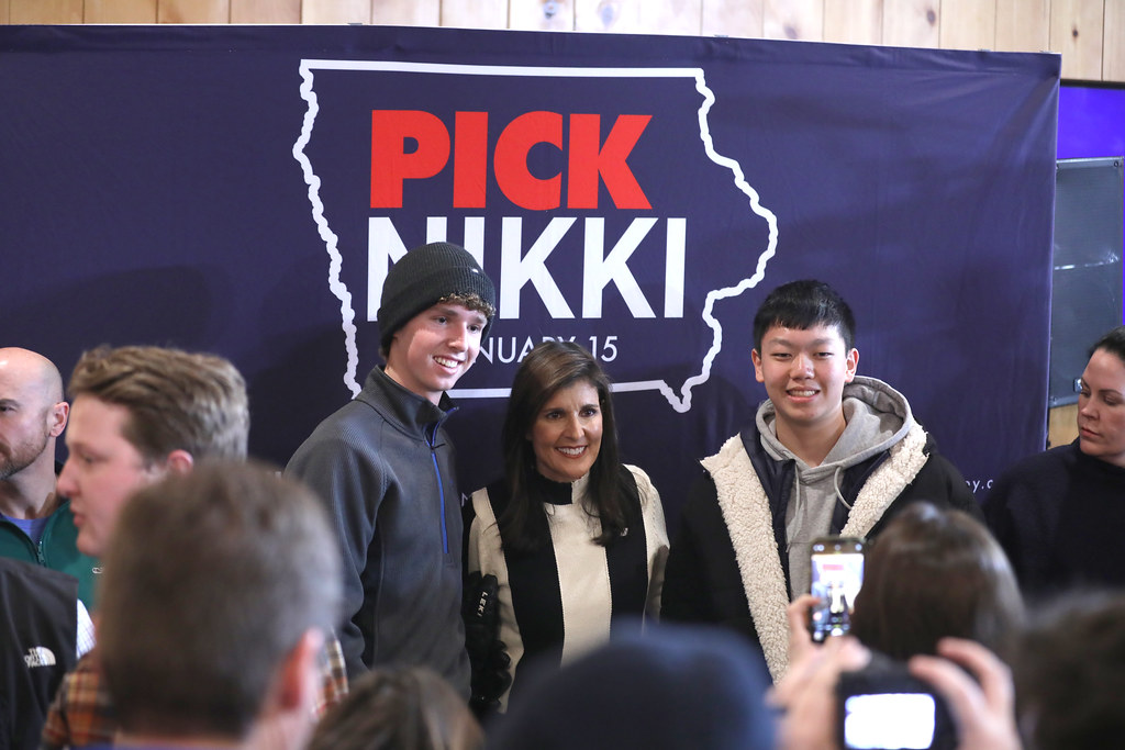 Among the crowded room, Nikki Haley connects with Iowas voters before the awaited Iowa Caucasus. 