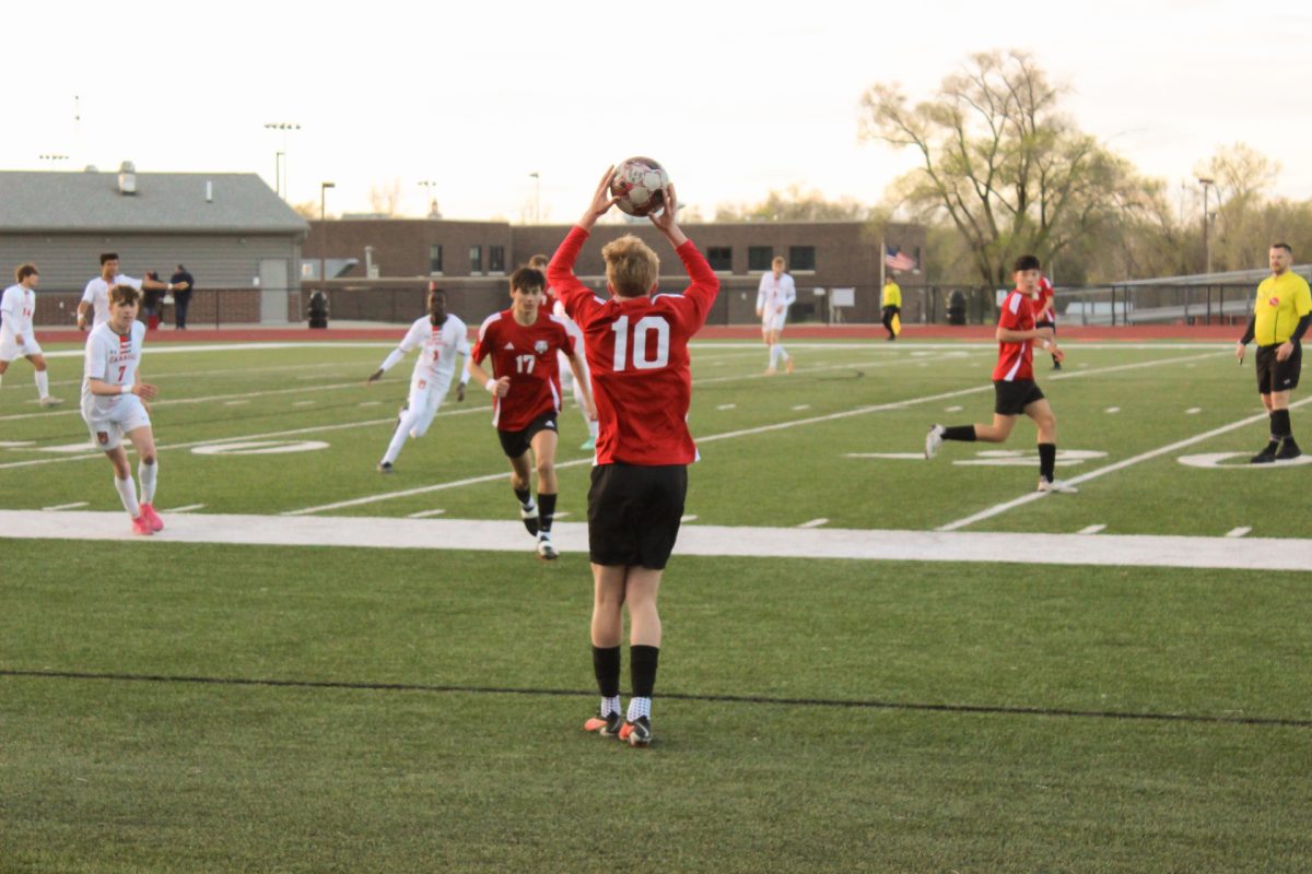 Throwing the ball back in bounds, sophomore Cael Orban passes it to his teammates eager to score a goal. 