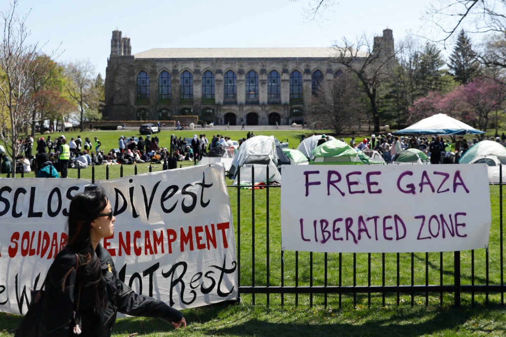 Signs are displayed in front of Deering Meadow, where an encampment of students are protesting in support of Palestinians, during the ongoing conflict between Israel and the Palestinian Islamist group Hamas, at Northwestern University campus in Evanston, Illinois