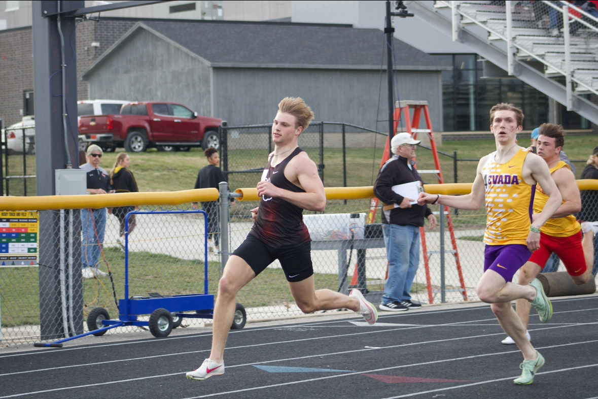 Senior Aiden Flora sprints to the finish line in a competition against Winterset.