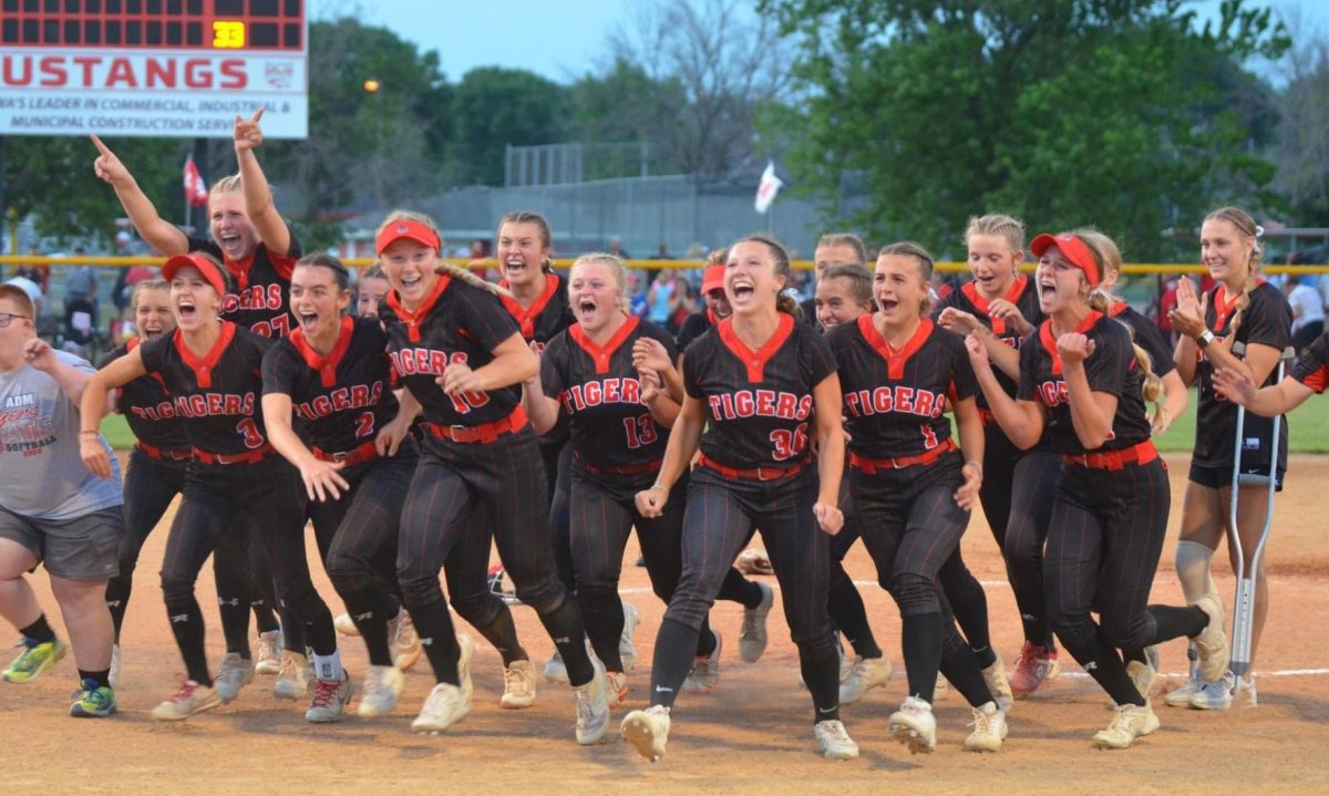Runnning towards the State Qualifier flag, the Softball team celebrated after beating DCG.
