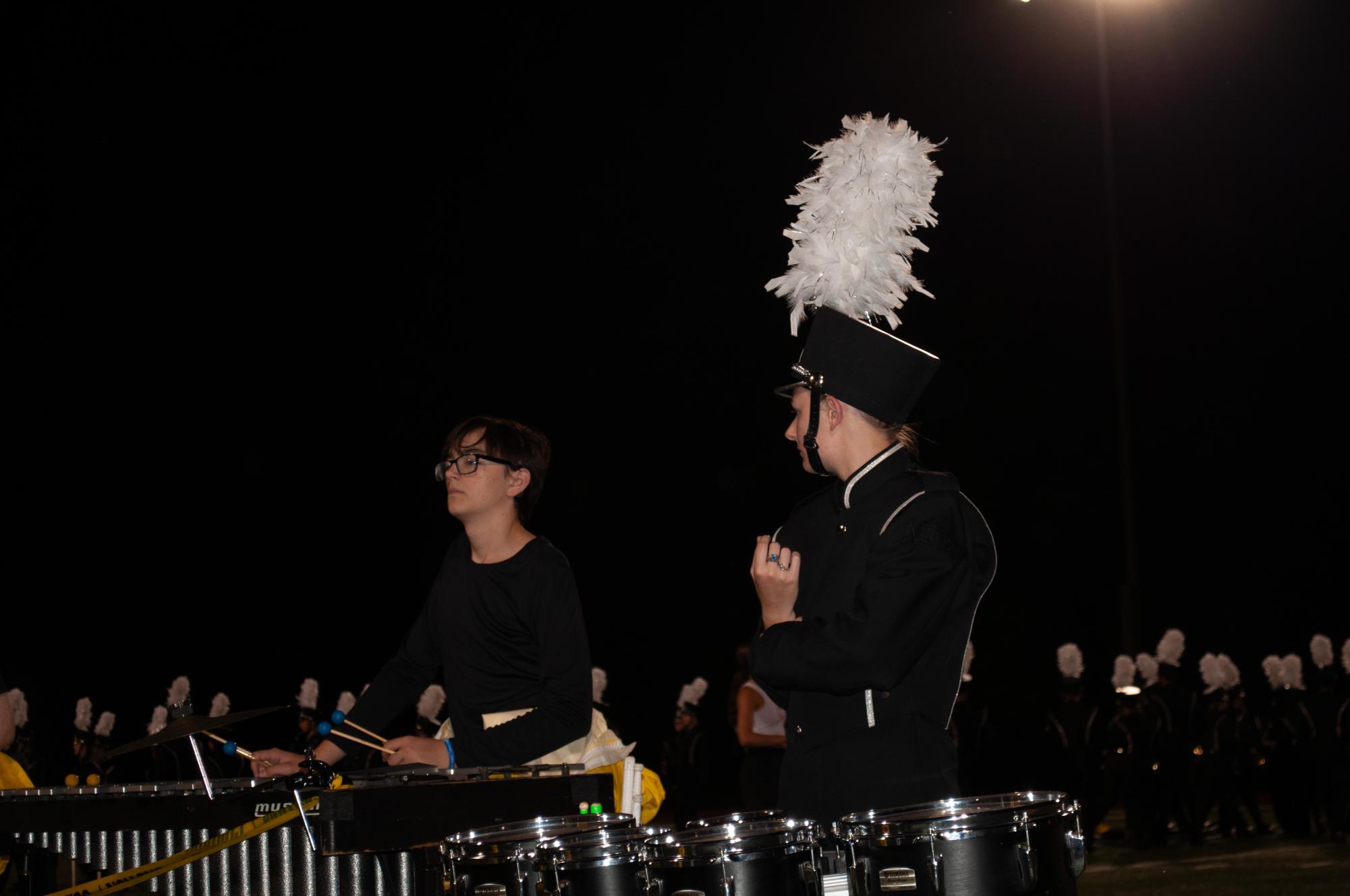 Percussionists, Caleb Klassen and Jocelyn Strunk, prepare for the marching band’s latest halftime show, Toxic. For this performance, Klassen performs on the vibraphone, while Strunk performs on the quads.