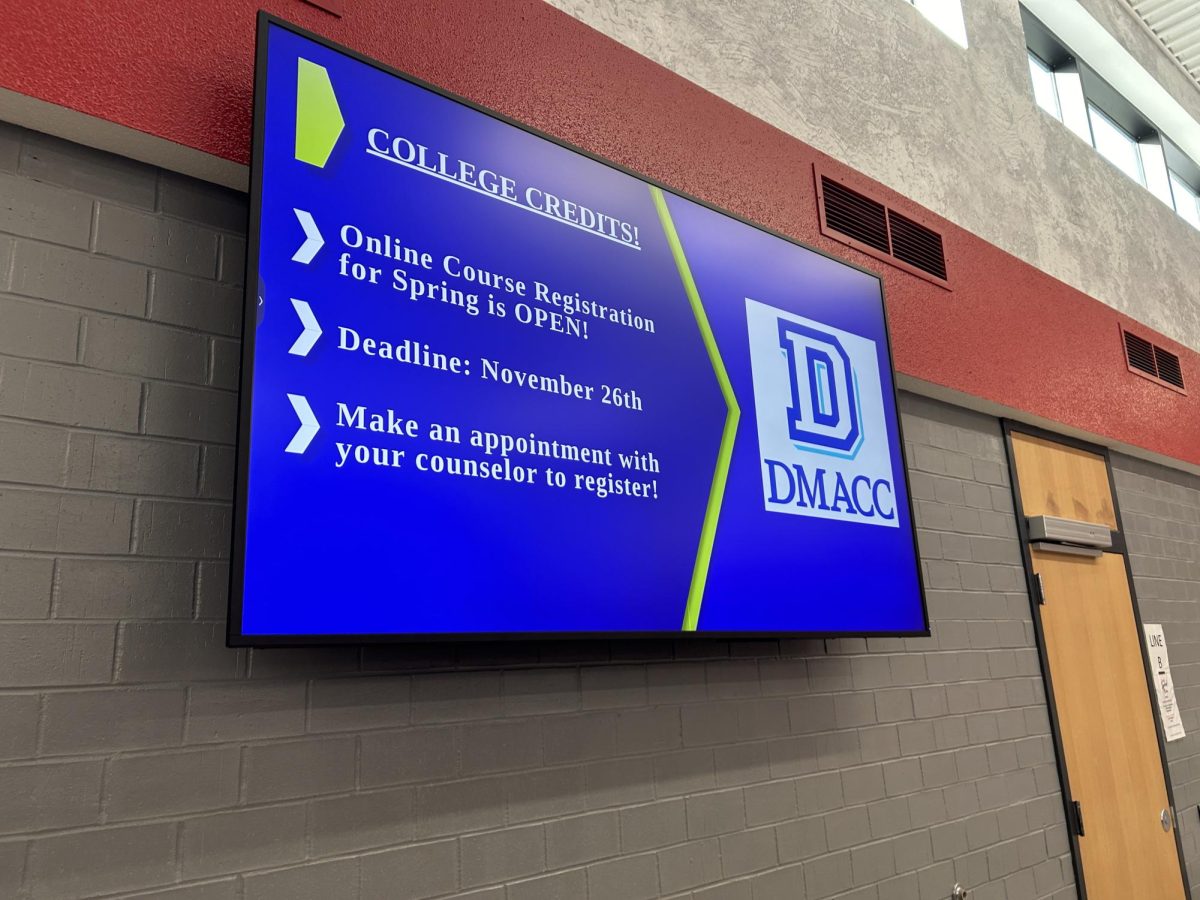 In the high school commons, the TVs displayed on the walls provide helpful information for students to refer to. Pictured on this TV are important dates and information regarding DMACC online courses.  