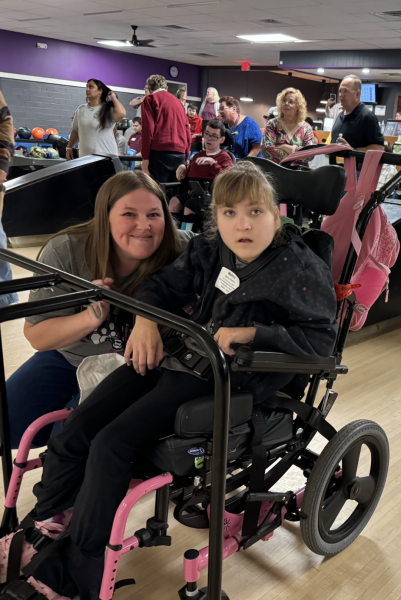 Junior Mallory Redmon goes to the bowling alley often with her family. Her associate Sara Carmichael attended the Special Olympics bowling to support her. 