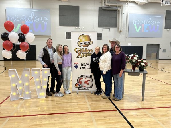 Mrs. Kreifels pictured with her family after being surprised with the Golden Apple Award at a Meadowview elementary assembly. 