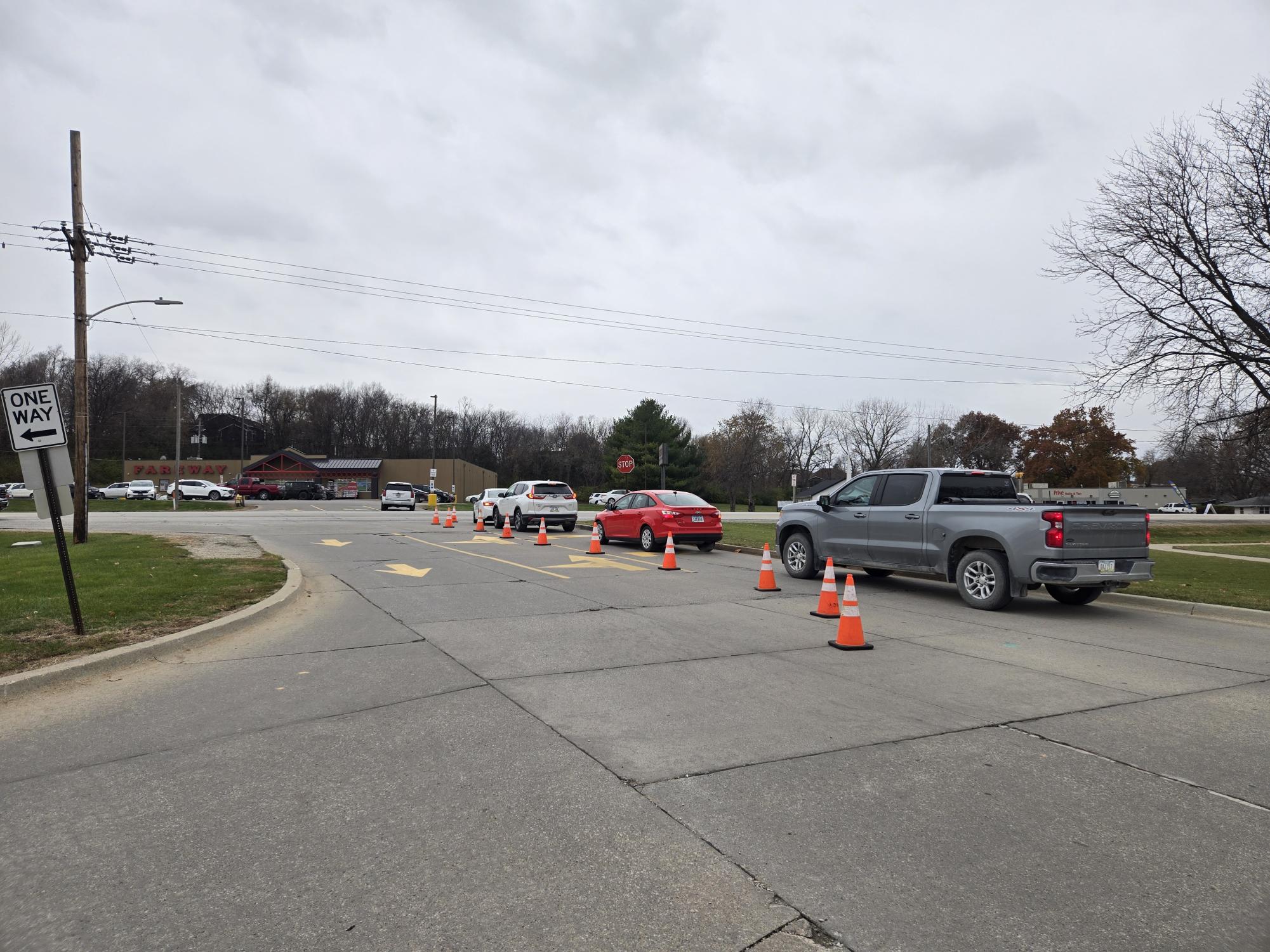Leaving after a day of school, a string of four cars must turn right due to the present cones blocking left turns.