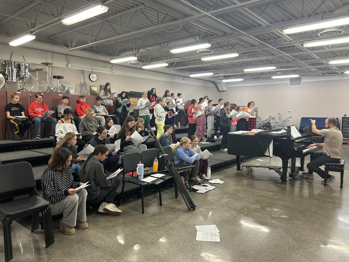 The show choir is up bright and early on a Thursday morning, practicing before school at 7am. They only worked on singing music and won’t add in dance choreography until they learn it at their 8-hour day camp on November 23. 