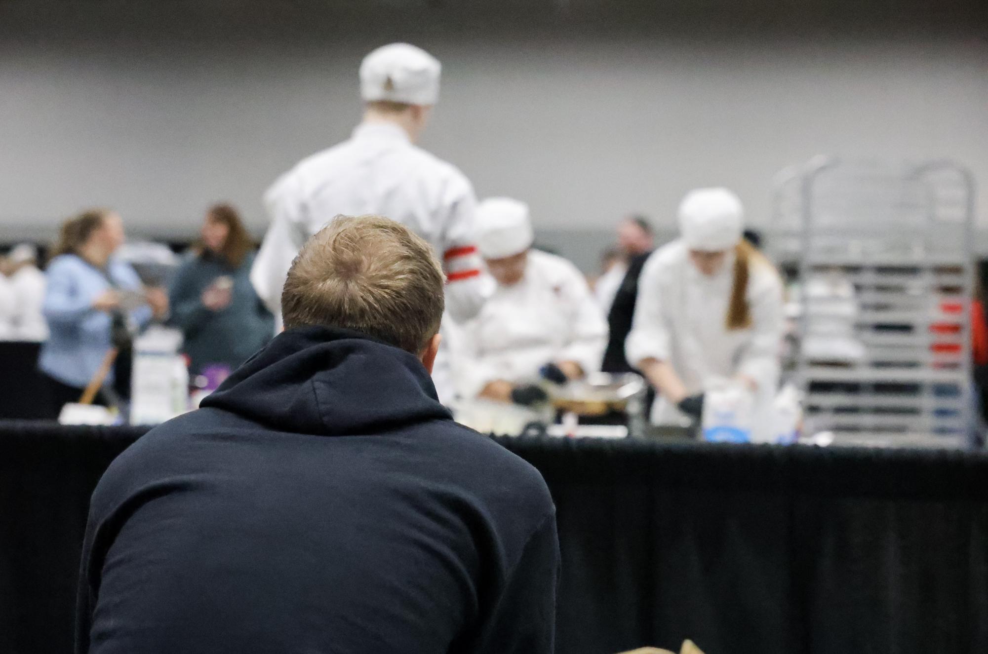 Silently Observing, Tyler Kubiak, chef, teacher and ADM's prostart team advisor watches his students work from the sidelines. While cooking in competition, students aren't allowed to talk or communicate to anyone except each other, meaning they had to ignore Kubiak and any family or friends there to support. "I'm always nervous, but not as much as last year. This team is good," Kubiak said.