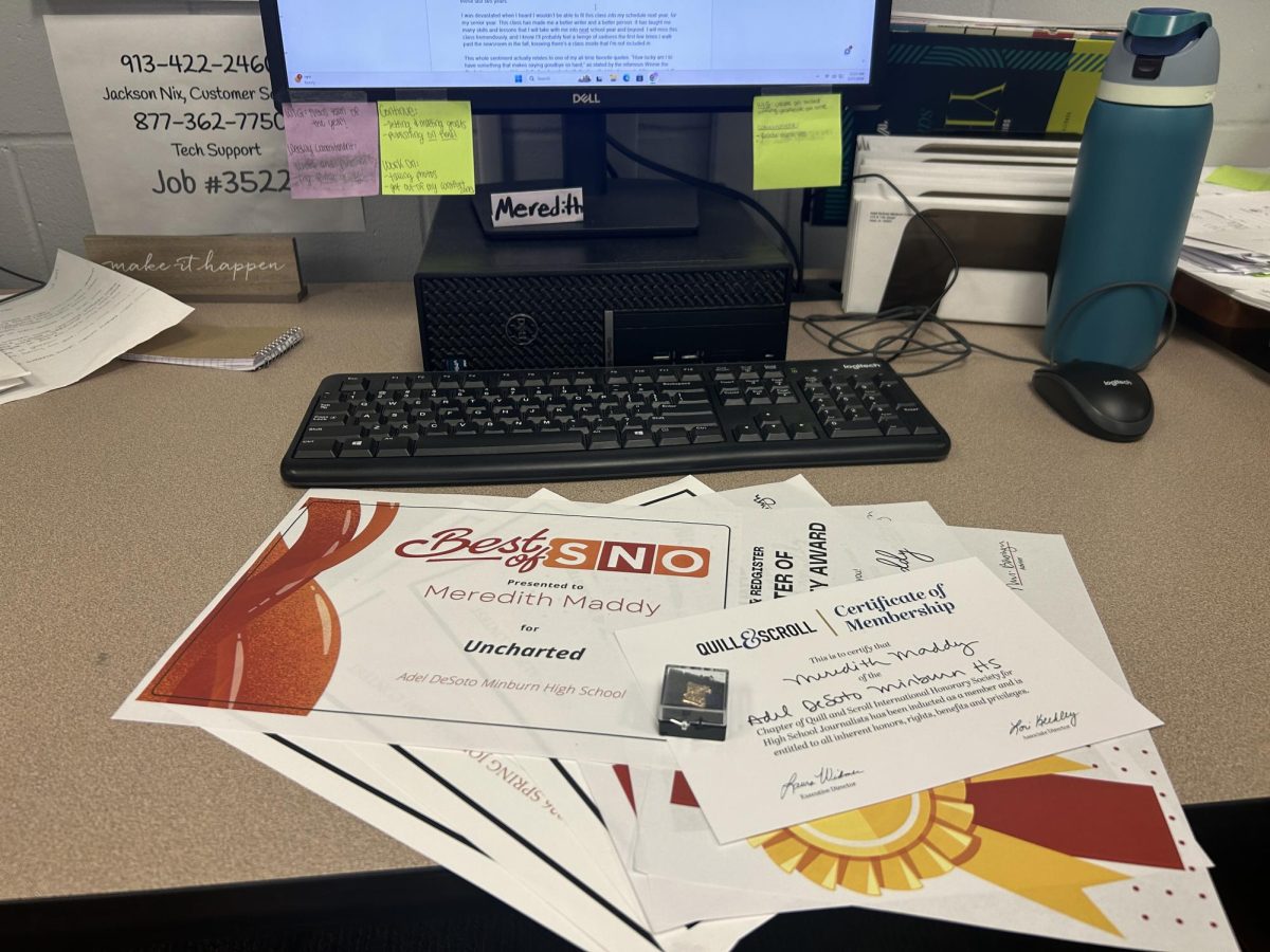 Some of the awards I've earned while on this staff sit on my desktop space that I've occupied for the past two years. My Quill & Scroll certificate and pin has been put on the top of the stack, as I was inducted during my very last day of news class.